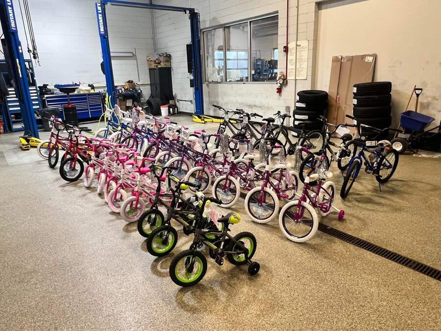Rows of new children’s bicycles lined up in a dealership service bay